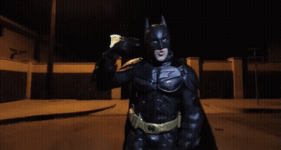 Man In Batman Costume Holding Soda Can GIF