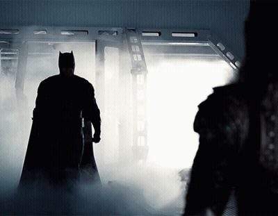 Man In Batman Costume Standing In Room With Smoke GIF