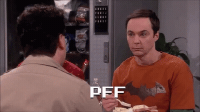Man In Batman Shirt Eating Chips Talking To Another Man GIF