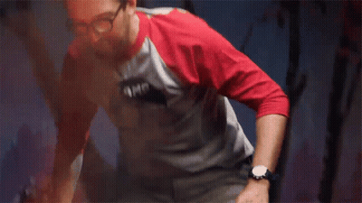Man In Batman Shirt Stretching Legs GIF