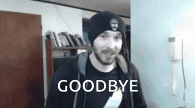 Man In Beanie And Hoodie Standing By Goodbye Sign GIF