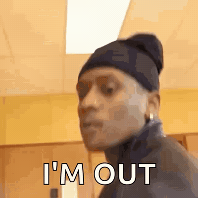Man In Beanie And Jacket Making Funny Face Saying I'm Out GIF