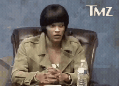 Man In Beanie And Jacket Sitting At Table GIF
