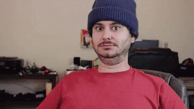 Man In Beanie And Red Shirt Sitting In Chair GIF