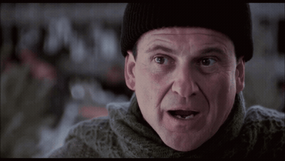 Man In Beanie And Sweater Looking At Camera GIF