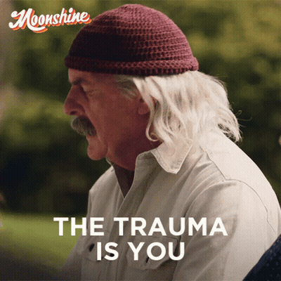 Man In Beanie And White Shirt Saying The Trauma Is You GIF