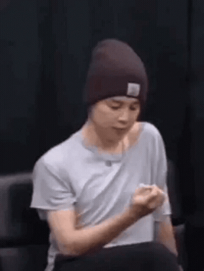 Man In Beanie Holding Fist Up GIF