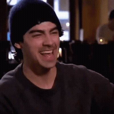 Man In Beanie Laughing With Eyes Closed GIF