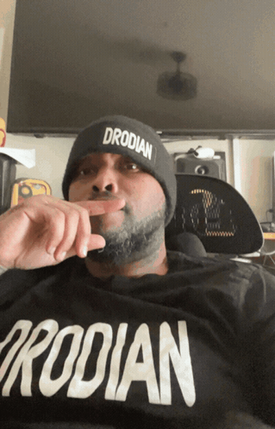 Man In Beanie Wearing Drodilan Shirt GIF