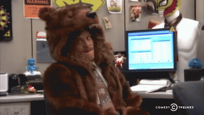 Man In Bear Costume At Desk With Warning Sign GIF