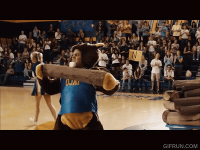 Man In Bear Costume Carrying Log With Chick Sign GIF