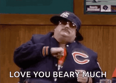 Man In Bear Jacket And Hat At Table GIF
