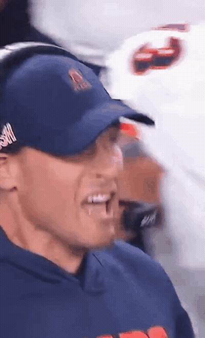 Man In Bear Sweatshirt Shaking Hands With Man Holding Football GIF
