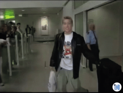 Man In Bear T-Shirt Walking Down Hallway GIF
