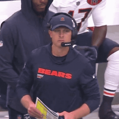 Man In Bears Shirt And Headphones Looking At Camera GIF
