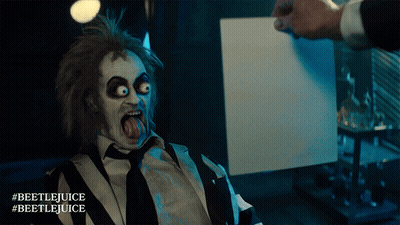 Man In Beetlejuice Costume Holding Paper GIF