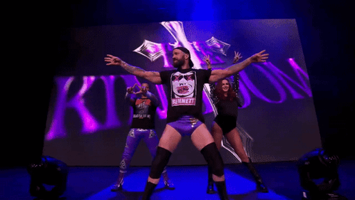 Man In Bennett Shirt In Front Of Crowd GIF