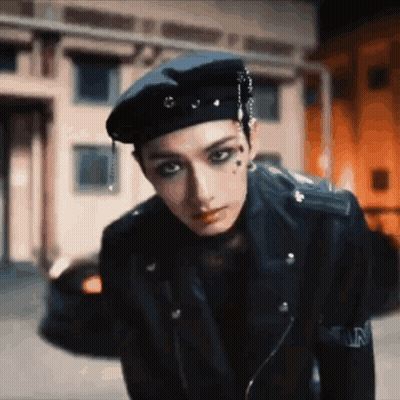 Man In Beret And Leather Jacket Standing On Street GIF