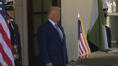 Man In BetMGM Shirt Holding Two American Flags GIF
