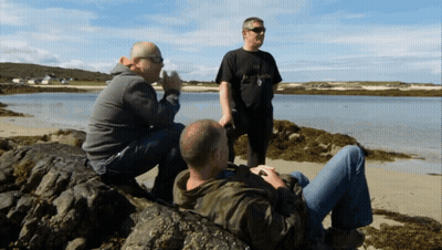 Man In Black Abercrombie & Fitch Shirt Sitting On Rock GIF