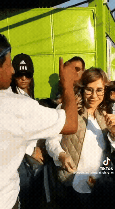 Man In Black Adidas Hat Thumbs Up To Woman In Glasses GIF