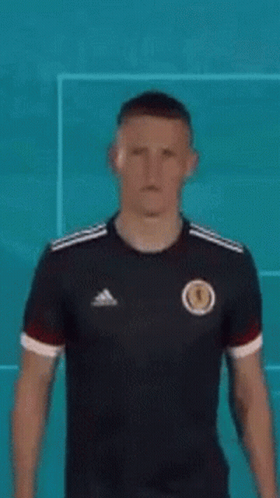 Man In Black Adidas Jersey By Blue Wall GIF