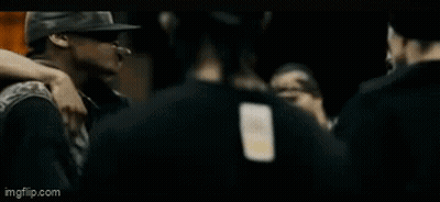Man In Black Adidas Shirt Talking To Man In Hat GIF