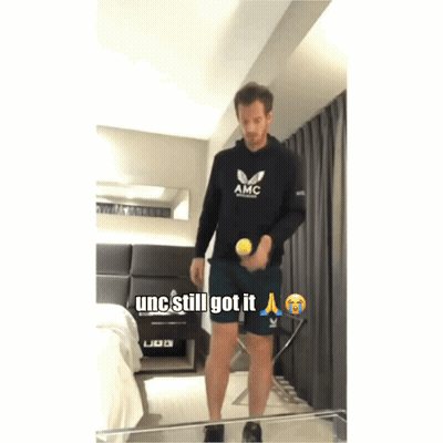 Man In Black AMC Sweatshirt Holding Tennis Ball GIF