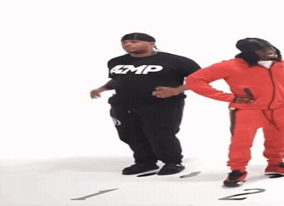 Man In Black Amp Shirt Next To Man In Red Jumpsuit GIF