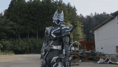 Man In Black And Blue Armor Before Junk Pile GIF