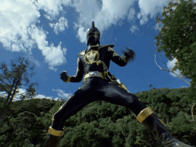 Man In Black And Gold Costume Jumping With Trees GIF