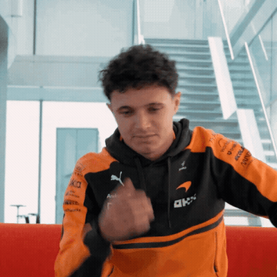 Man In Black And Orange Jacket With AKK GIF