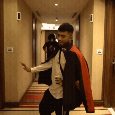 Man In Black And Red Jacket Dancing In Hallway GIF