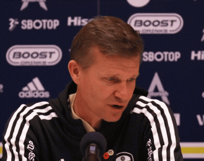 Man In Black And White Adidas Jacket In Front Of Boost Sign GIF