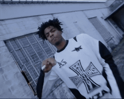 Man In Black And White Cross Shirt Smoking GIF