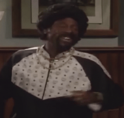 Man In Black And White Jacket And Necklace Smiling GIF