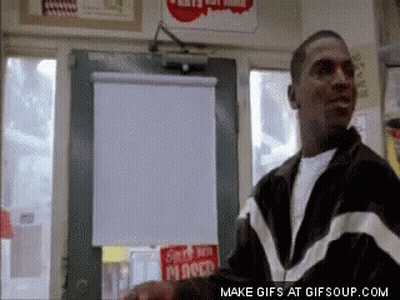Man In Black And White Jacket In Front Of Mr Roco Sign GIF