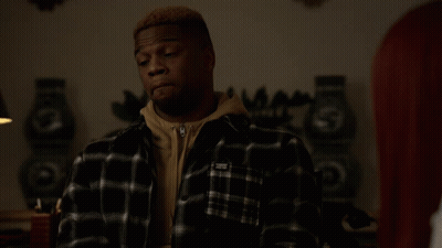 Man In Black And White Plaid Shirt With White Sticker On Sleeve GIF