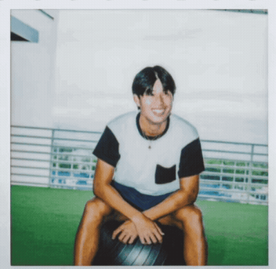 Man In Black And White Shirt Sitting On Black Ball GIF
