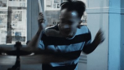 Man In Black And White Striped Shirt Holding Bat GIF