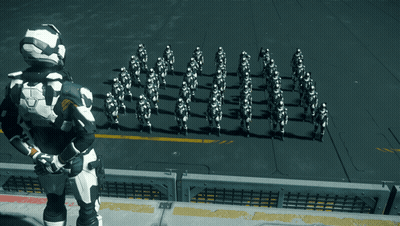 Man In Black And White Suit Before Soldiers In White GIF