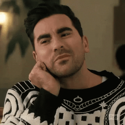 Man In Black And White Sweater Sitting At Table GIF
