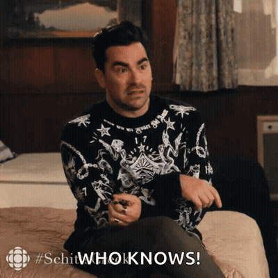 Man In Black And White Sweater Sitting On Bed Saying Schitwhoknows GIF