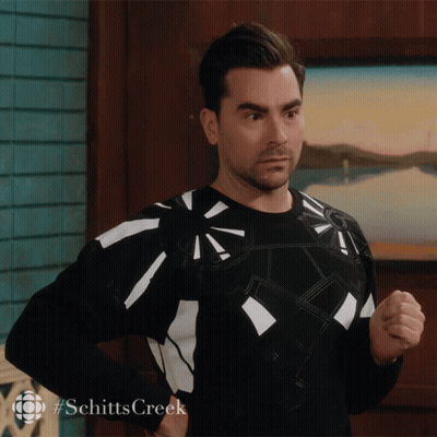 Man In Black And White Sweater With #Schitts Creek GIF