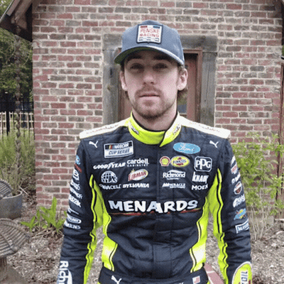 Man In Black And Yellow Menards Jacket By Brick Building GIF