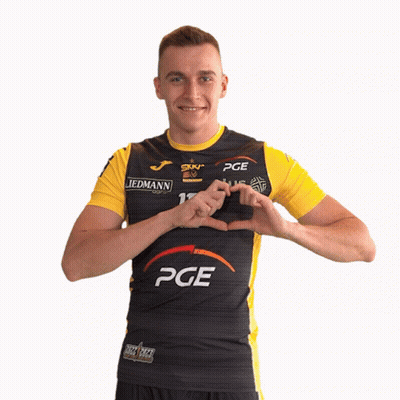 Man In Black And Yellow PGE Shirt Making Heart Shape With Hands GIF