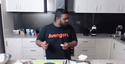 Man In Black Avengers Shirt Holding Spoon GIF