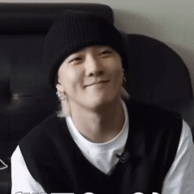 Man In Black Beanie And Black Vest Smiling GIF