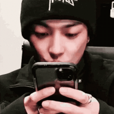 Man In Black Beanie Looking At Phone GIF