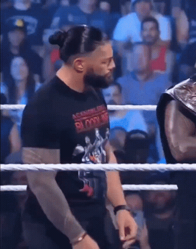 Man In Black Bloodline Shirt In Wrestling Ring GIF
